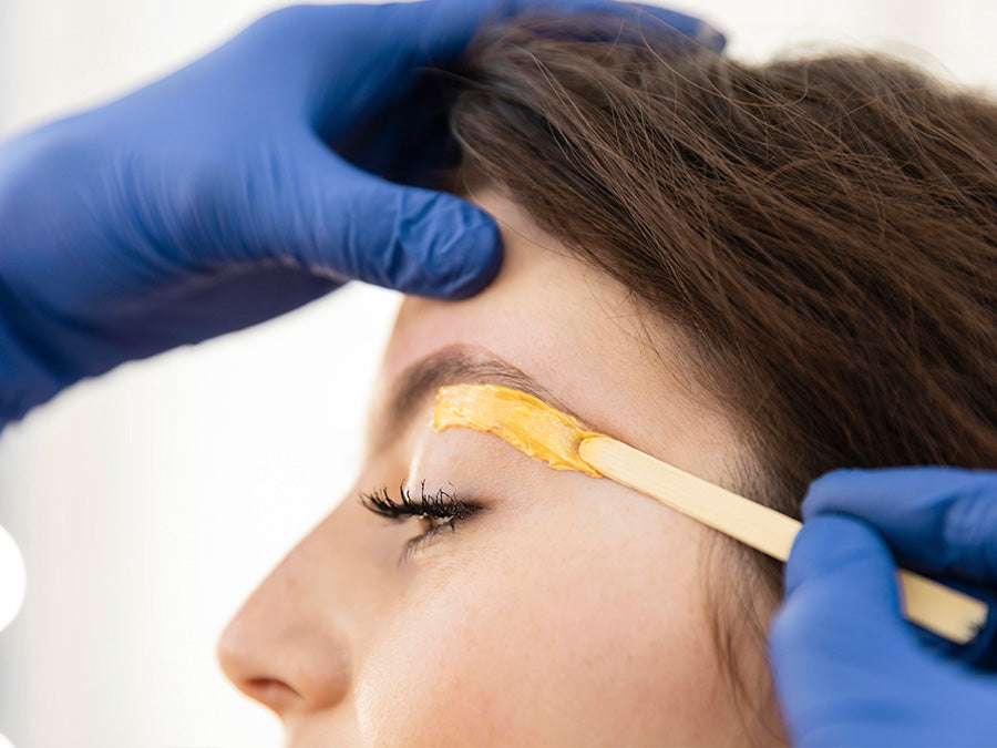 Professional eyebrow waxing session at New York Wax, Coral Springs, showcasing expertly shaped brows.